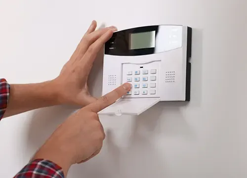 Alarm system keypad and motion sensors in a modern home.