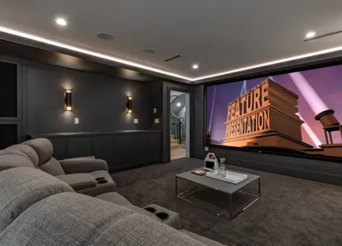 Flat-screen TV and surround speakers setup in a stylish living room.