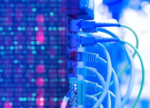 Technician organizing network cables in a rack cabinet.