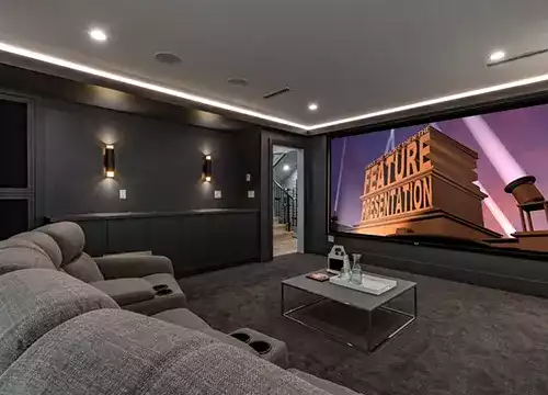 Flat-screen TV and surround speakers setup in a stylish living room.